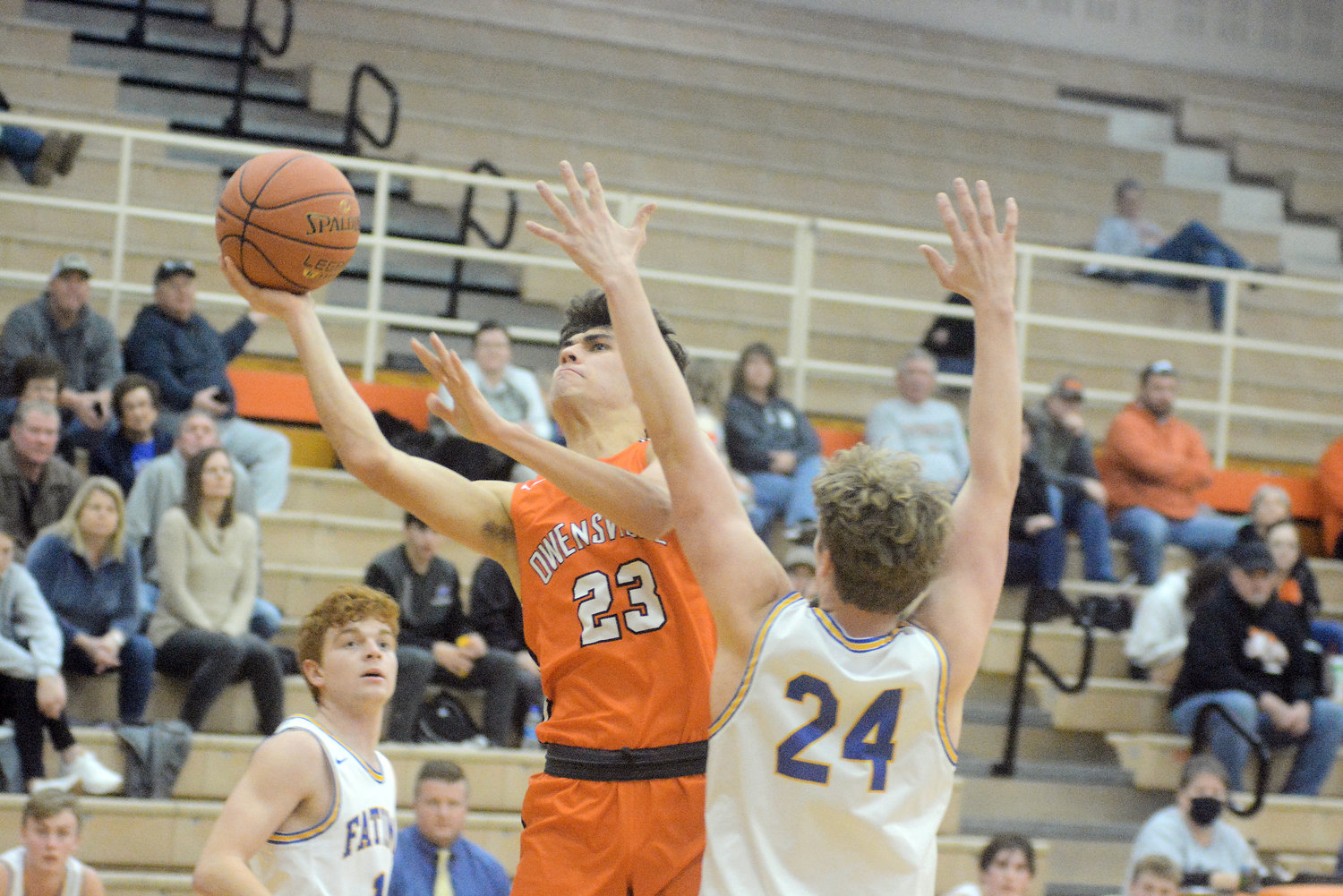 Landon Valley (left) aggressively attacks the basket against the Comet defense.